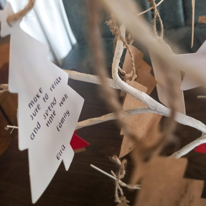 The message on the Christmas tree ornament reads:

"Make sure to relax and spend time with family."